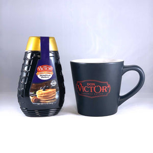 Bottle of Don Victor natural blueberry flavored honey beside a steaming mug of hot blueberry green tea with honey.