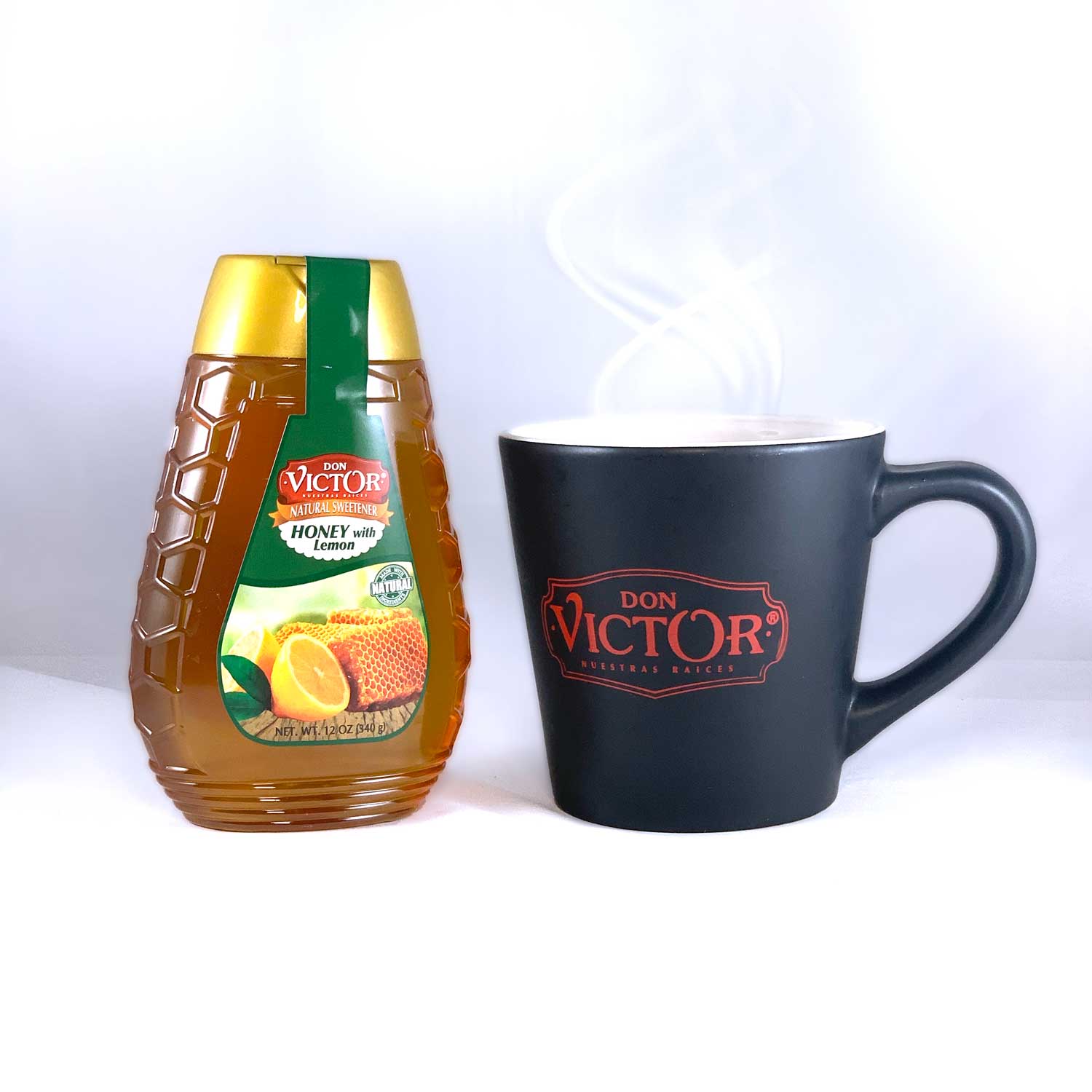 Bottle of Don Victor natural lemon flavored honey beside a mug of hot lemon honey tea.